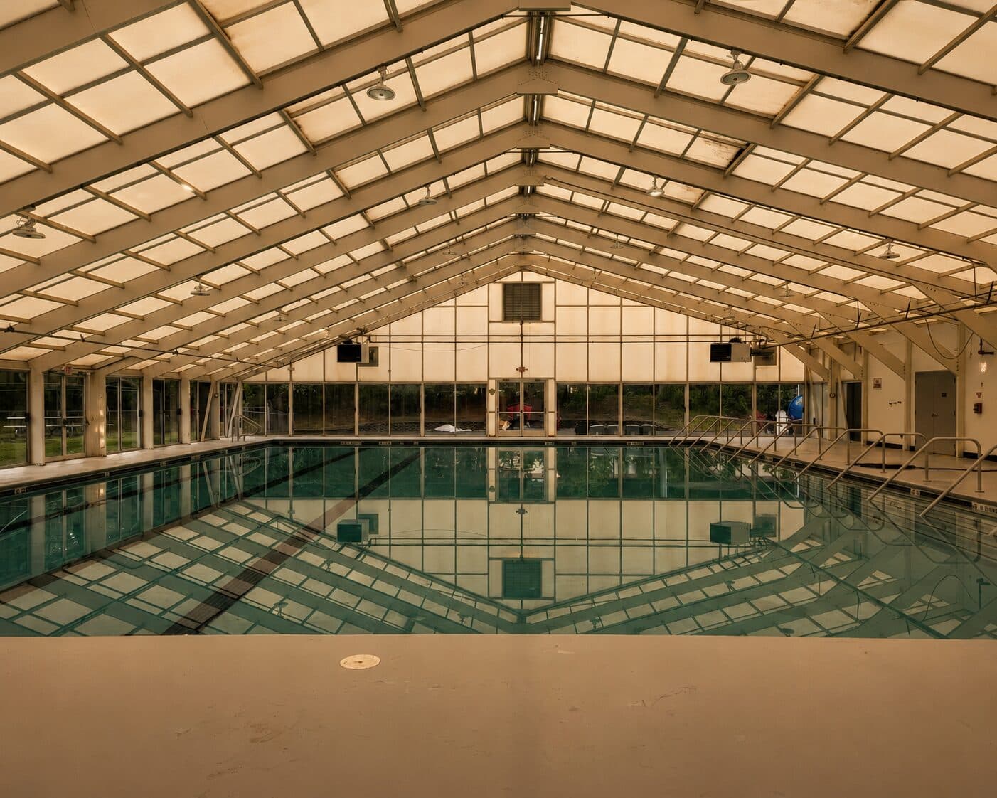 Indoor pool at Sanctuary Fitness, beneath a vaulted roof that brings in natural light.